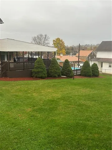 a backyard of a house with table and chairs