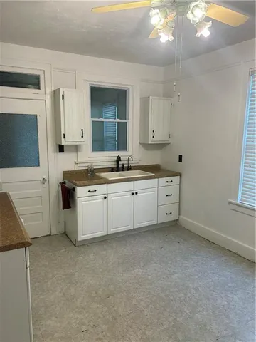 a spacious bathroom with a granite countertop sink and a mirror