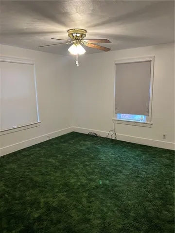 a view of a room with window & ceiling fan