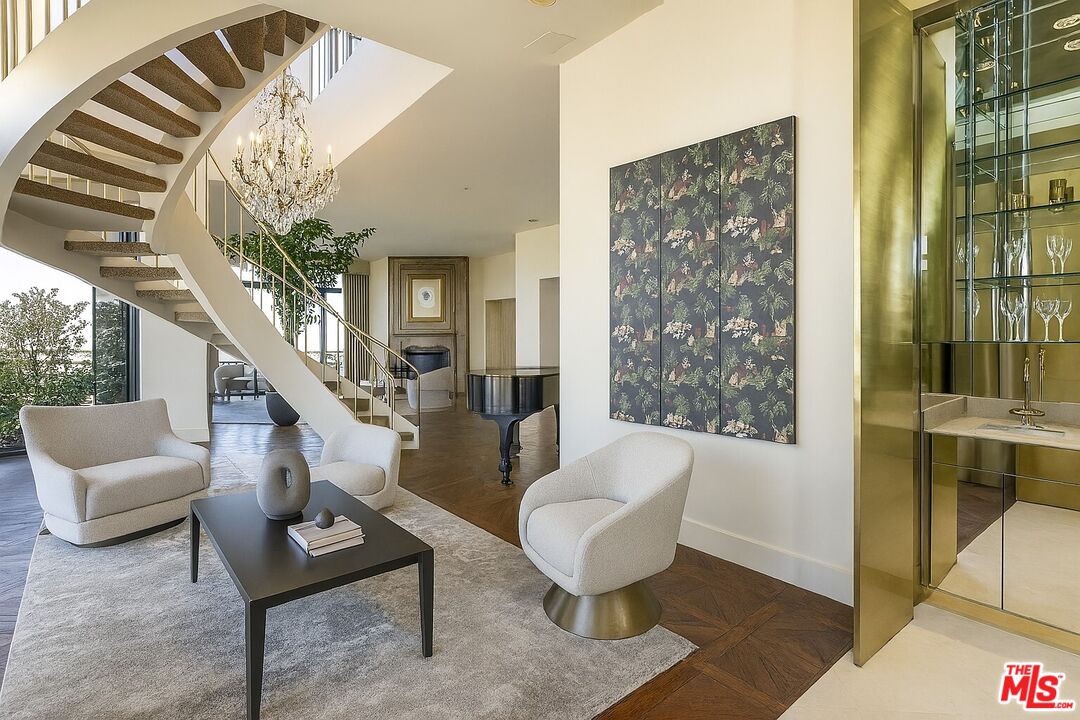 10601 Wilshire Boulevard, Unit PH E Los Angeles, CA 90024 - Photo 4 of 10 a living room with furniture and a chandelier