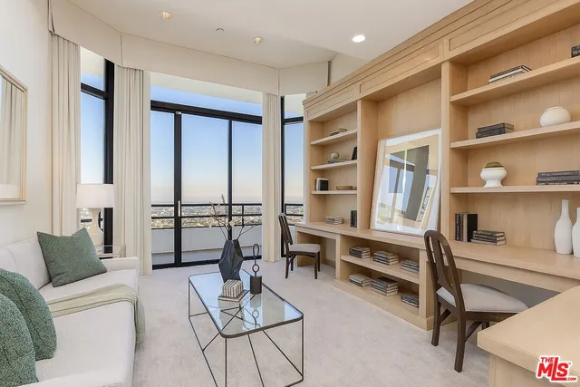 a living room with furniture a rug and white walls