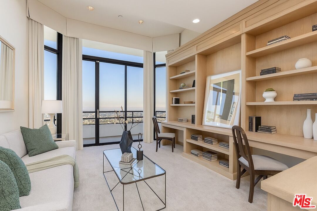 10601 Wilshire Boulevard, Unit PH E Los Angeles, CA 90024 - Photo 7 of 10 a living room with furniture a rug and white walls