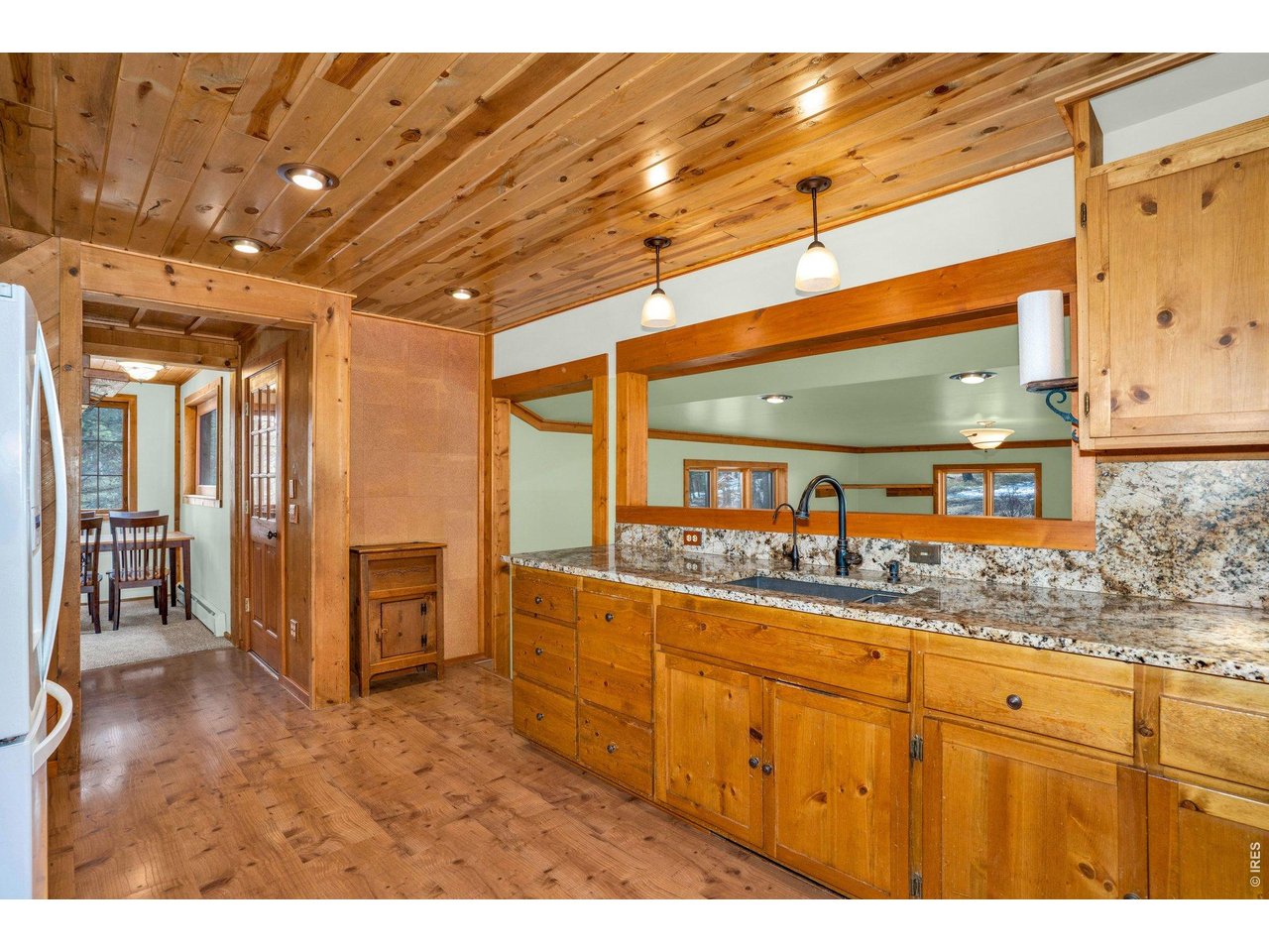 251 Haugen Slide Road Allenspark, CO 80510 - Photo 15 of 42 a kitchen with stainless steel appliances kitchen island granite countertop a sink and cabinets