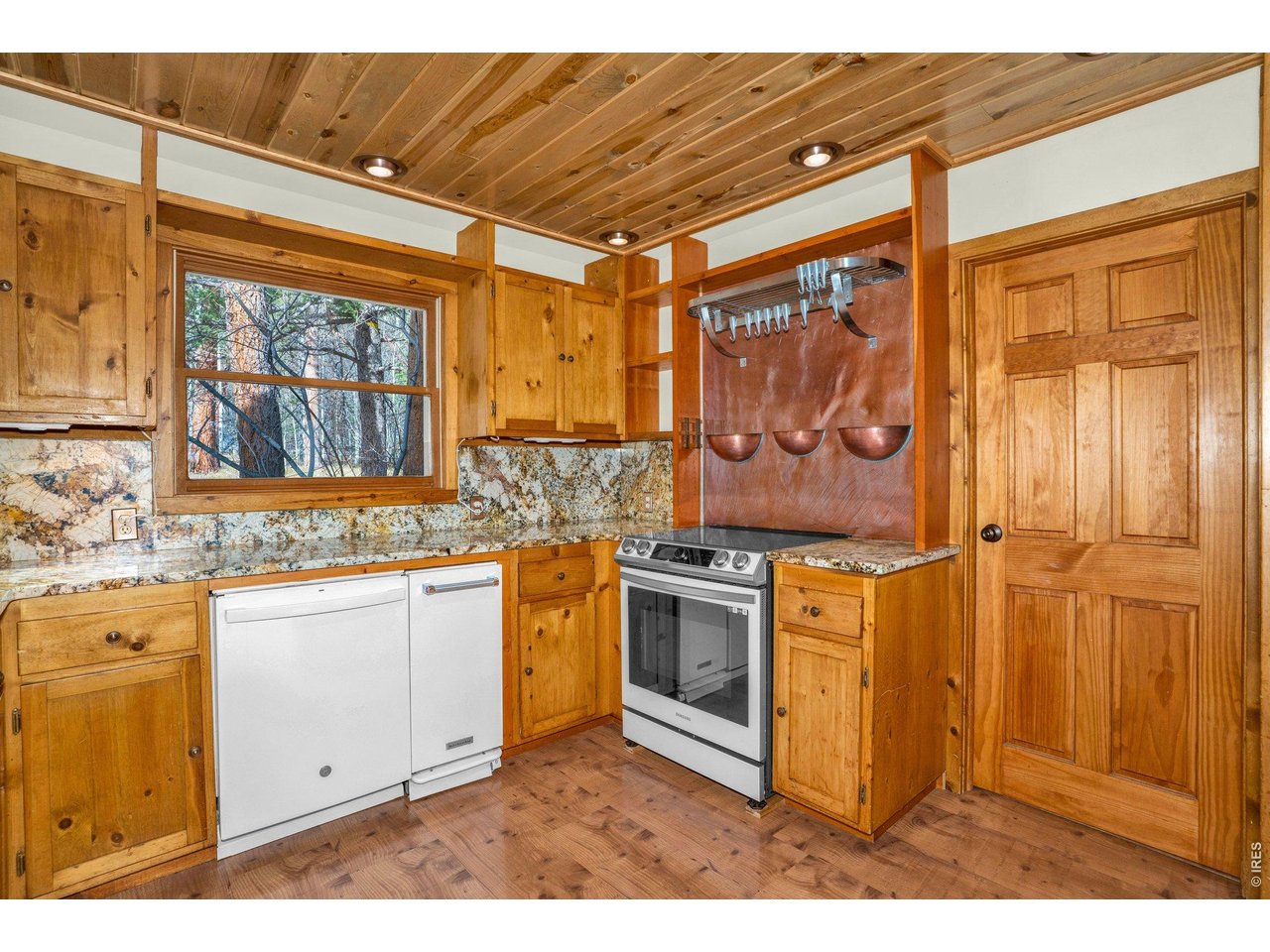251 Haugen Slide Road Allenspark, CO 80510 - Photo 20 of 42 a kitchen with stainless steel appliances granite countertop a stove a sink and a refrigerator