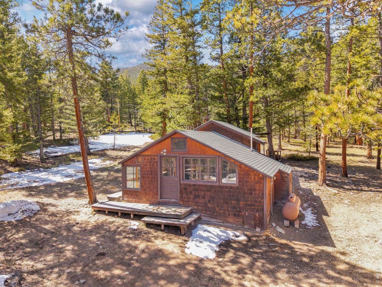 251 Haugen Slide Road Allenspark, CO 80510 - Photo 29 of 42 a backyard of a house with table and chairs