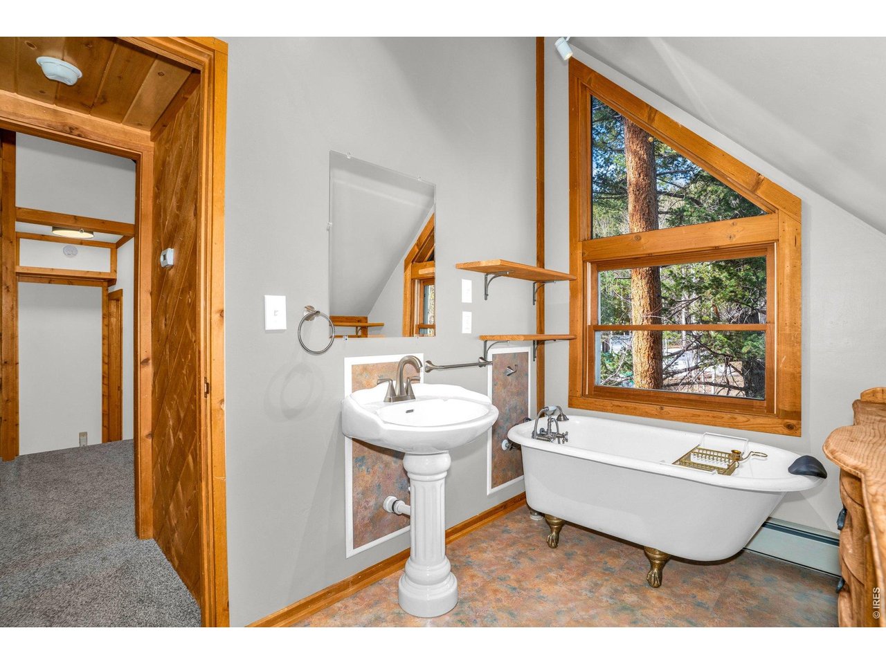 251 Haugen Slide Road Allenspark, CO 80510 - Photo 35 of 42 a living room with a large window and a table