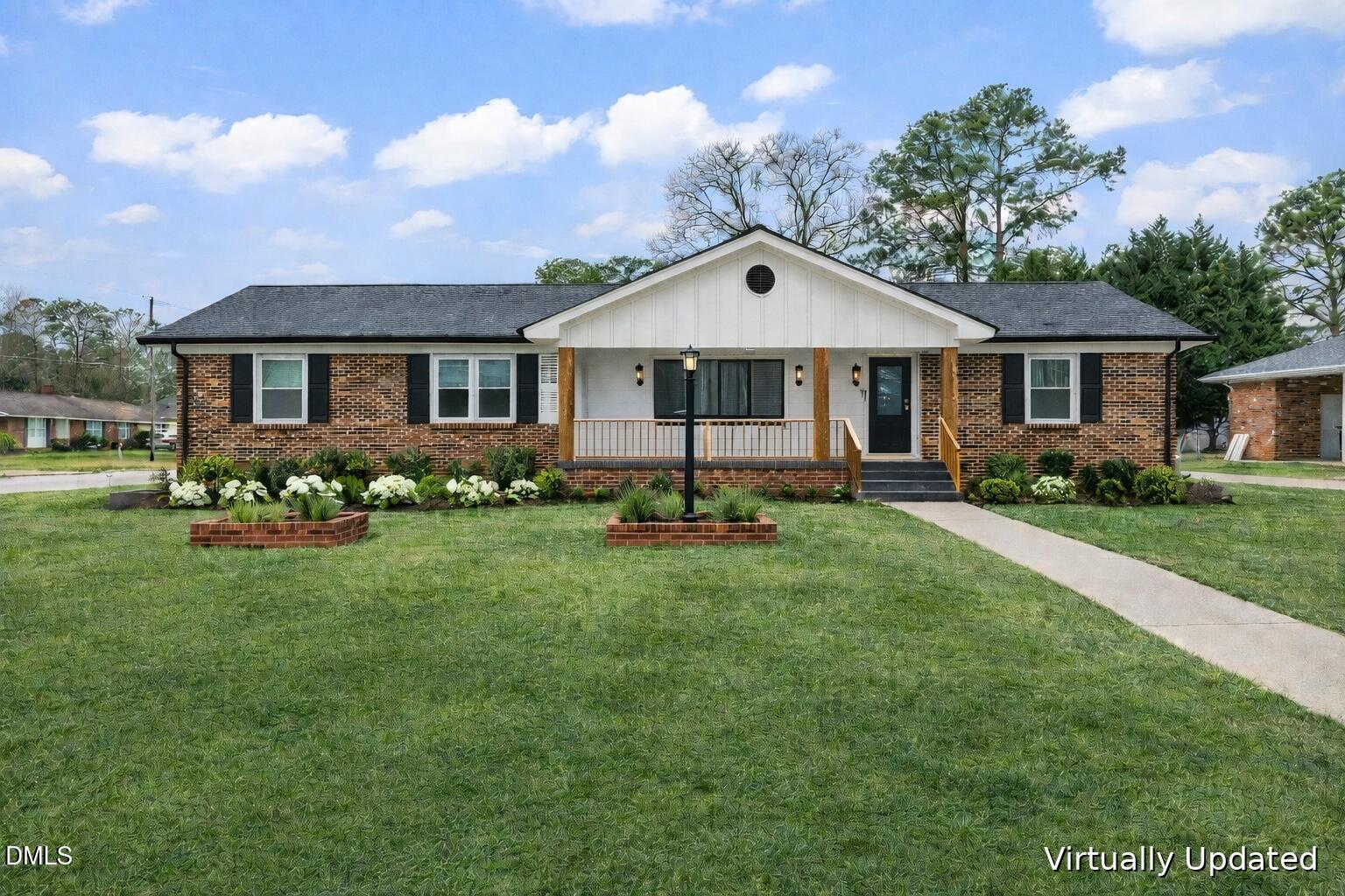 607 Bedford Road Fayetteville, NC 28303 - Photo 2 of 35 a front view of a house with a garden and trees