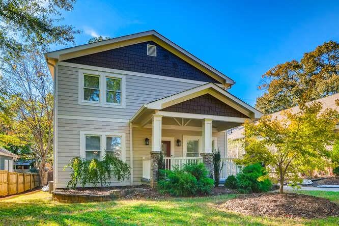 a front view of a house with a garden