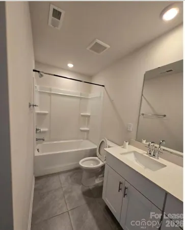 a bathroom with a double vanity sink toilet mirror and bathtub