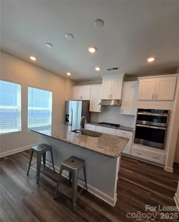 a kitchen with a sink appliances and cabinets