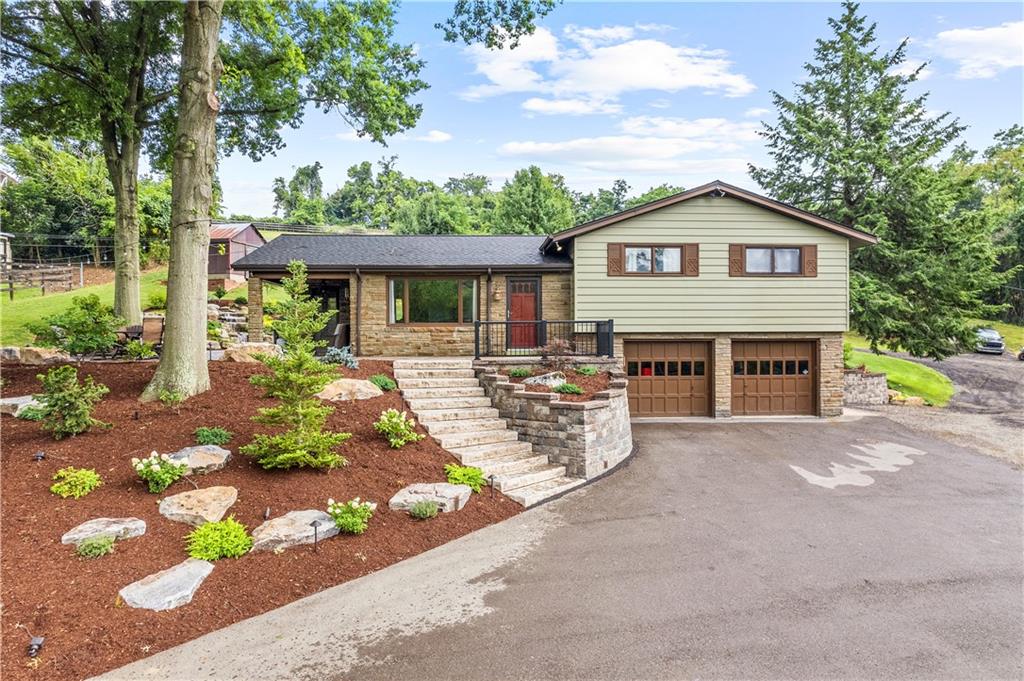 a front view of a house with a yard and outdoor seating