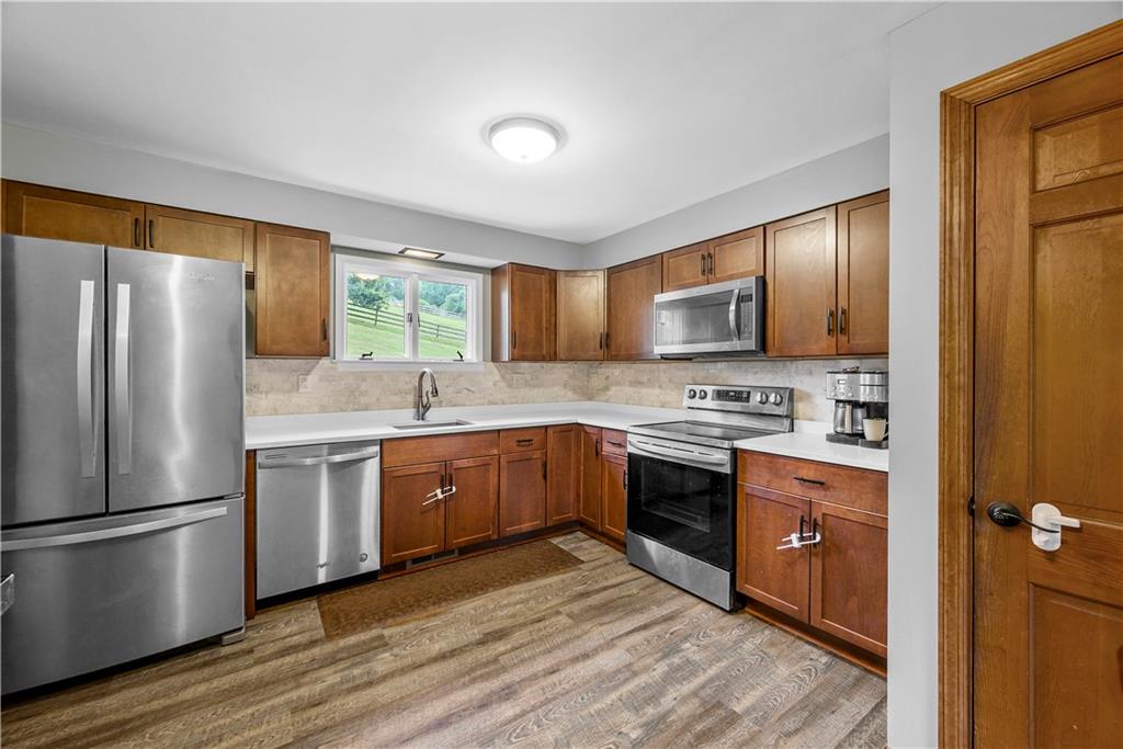 249 Fulton Road Canonsburg, PA 15317 - Photo 5 of 25 a kitchen with stainless steel appliances granite countertop a stove refrigerator sink and microwave