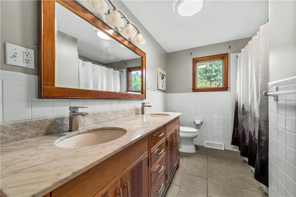 249 Fulton Road Canonsburg, PA 15317 - Photo 8 of 25 a bathroom with a granite countertop sink toilet and a mirror