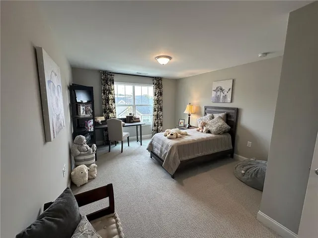 a bedroom with a bed and furniture