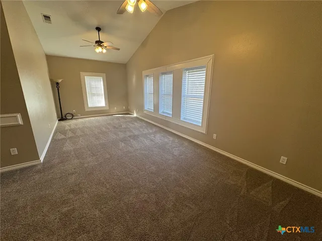 a bathroom with a granite countertop double vanity sink and mirror