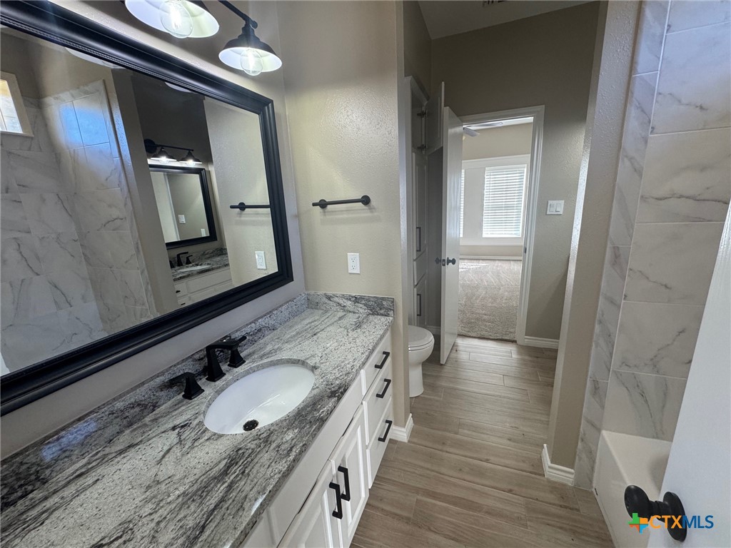 2776 South Highway 77 Cameron, TX 76520 - Photo 17 of 30 a bathroom with a granite countertop double vanity sink and mirror