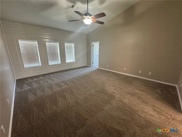 a spacious bathroom with a granite countertop sink a mirror and a shower