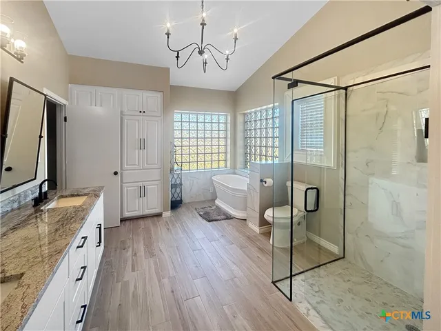 a bathroom with a sink a mirror and shower
