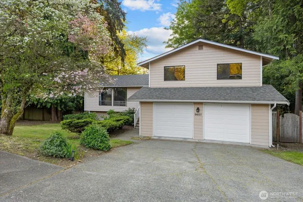 a view of a house with a yard and garage