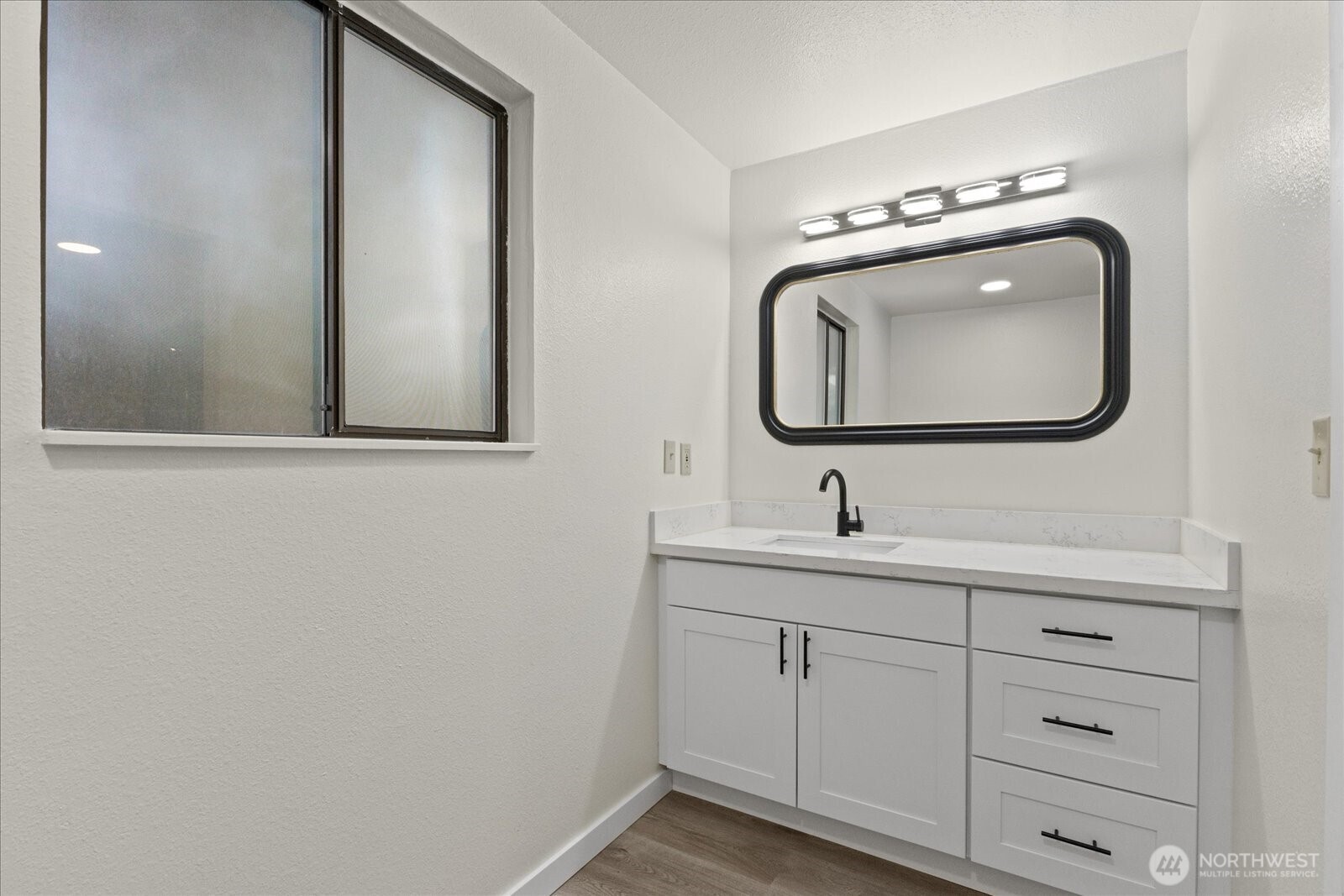 9607 122nd Avenue Southeast Renton, WA 98056 - Photo 15 of 32 a bathroom with a sink vanity and mirror