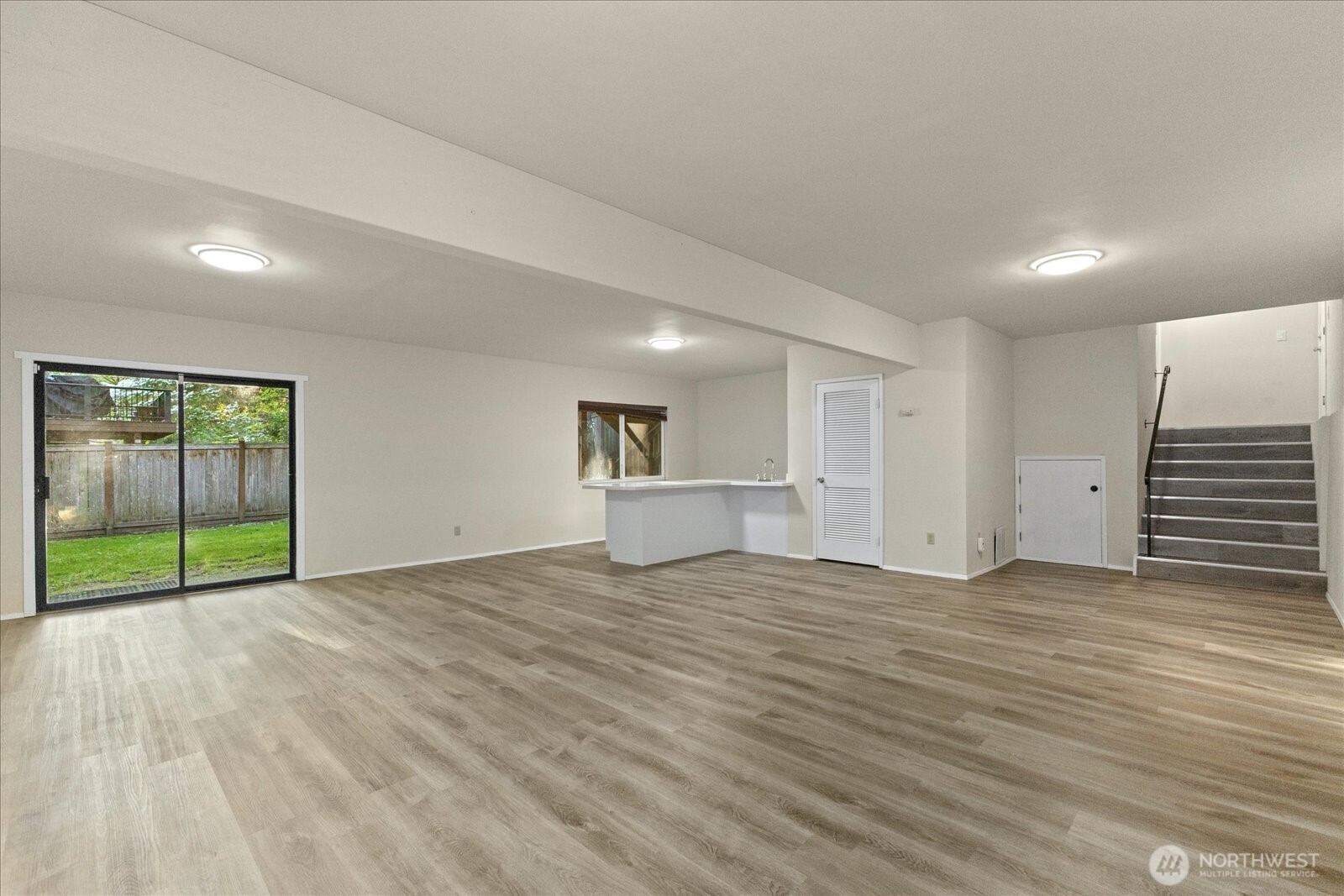 9607 122nd Avenue Southeast Renton, WA 98056 - Photo 16 of 32 a view of empty room with wooden floor and fan