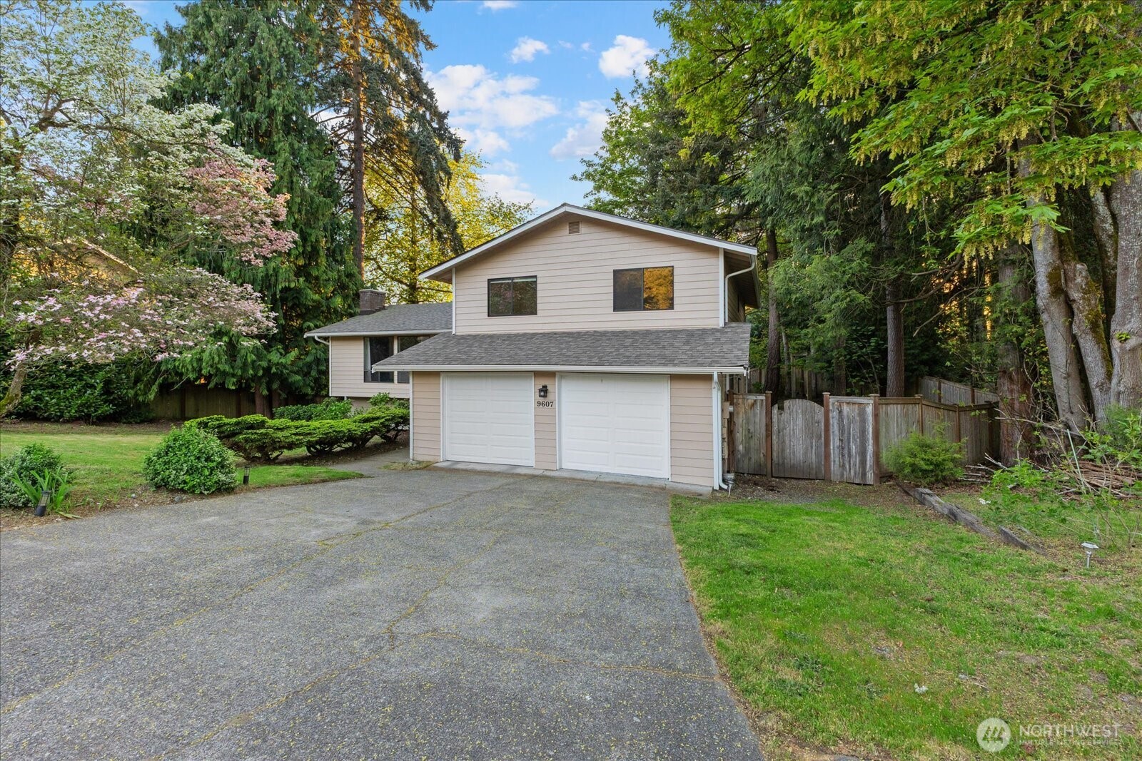 9607 122nd Avenue Southeast Renton, WA 98056 - Photo 2 of 32 a front view of a house with a yard and garage