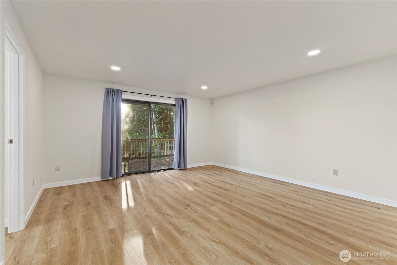 9607 122nd Avenue Southeast Renton, WA 98056 - Photo 23 of 32 a view of an empty room with wooden floor and a window