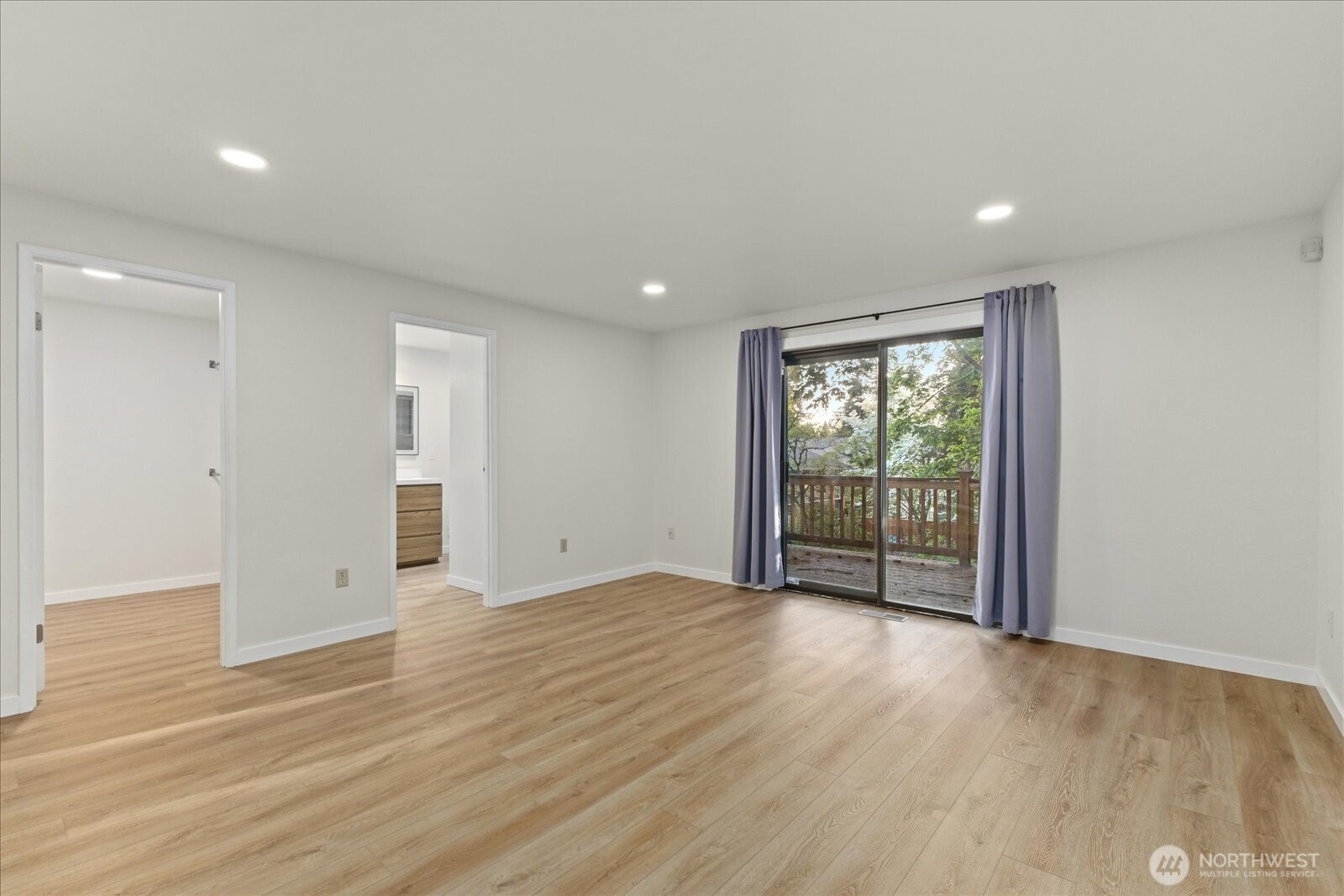 9607 122nd Avenue Southeast Renton, WA 98056 - Photo 26 of 32 a view of an empty room with wooden floor and a window