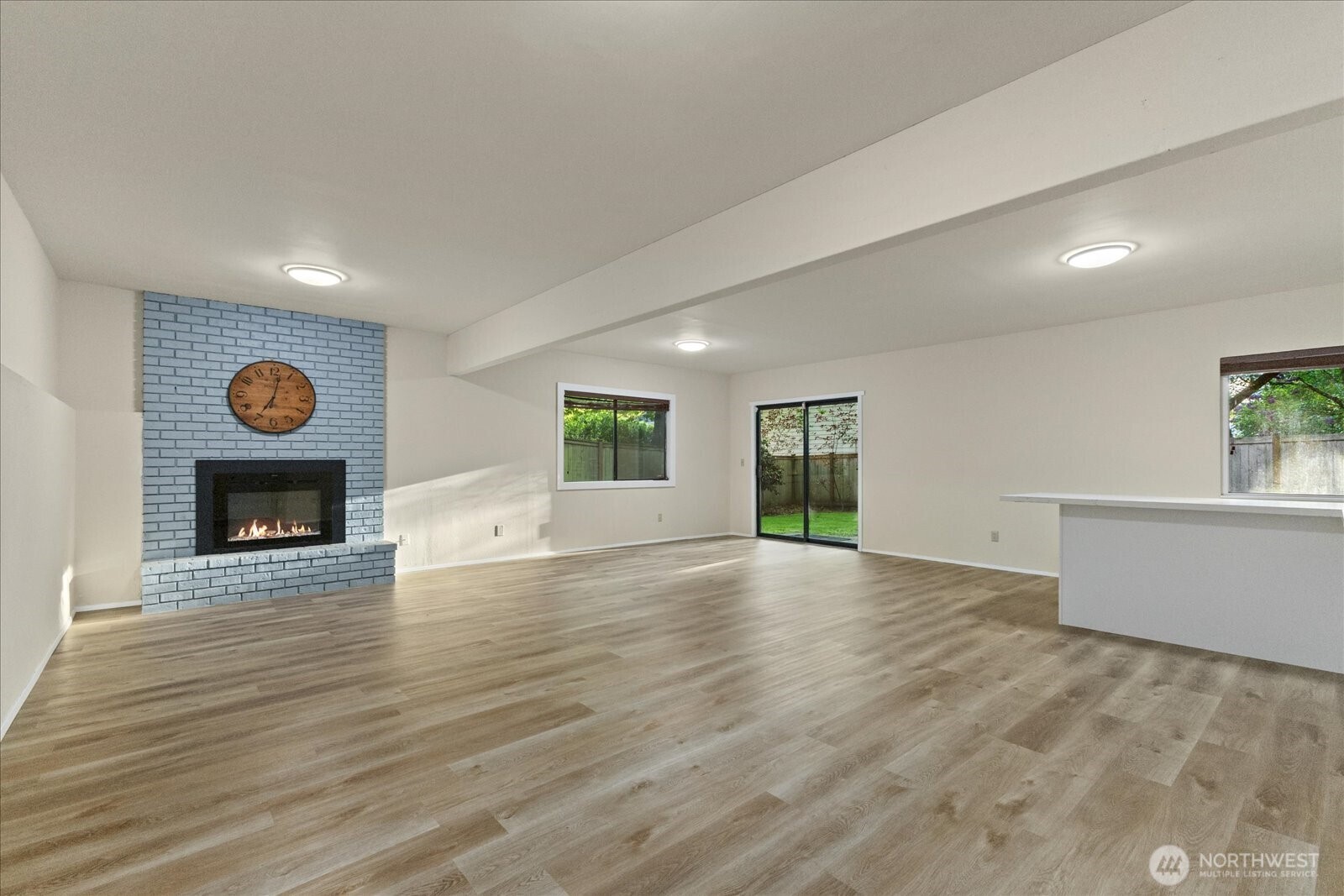 9607 122nd Avenue Southeast Renton, WA 98056 - Photo 6 of 32 an empty room with wooden floor and fireplace