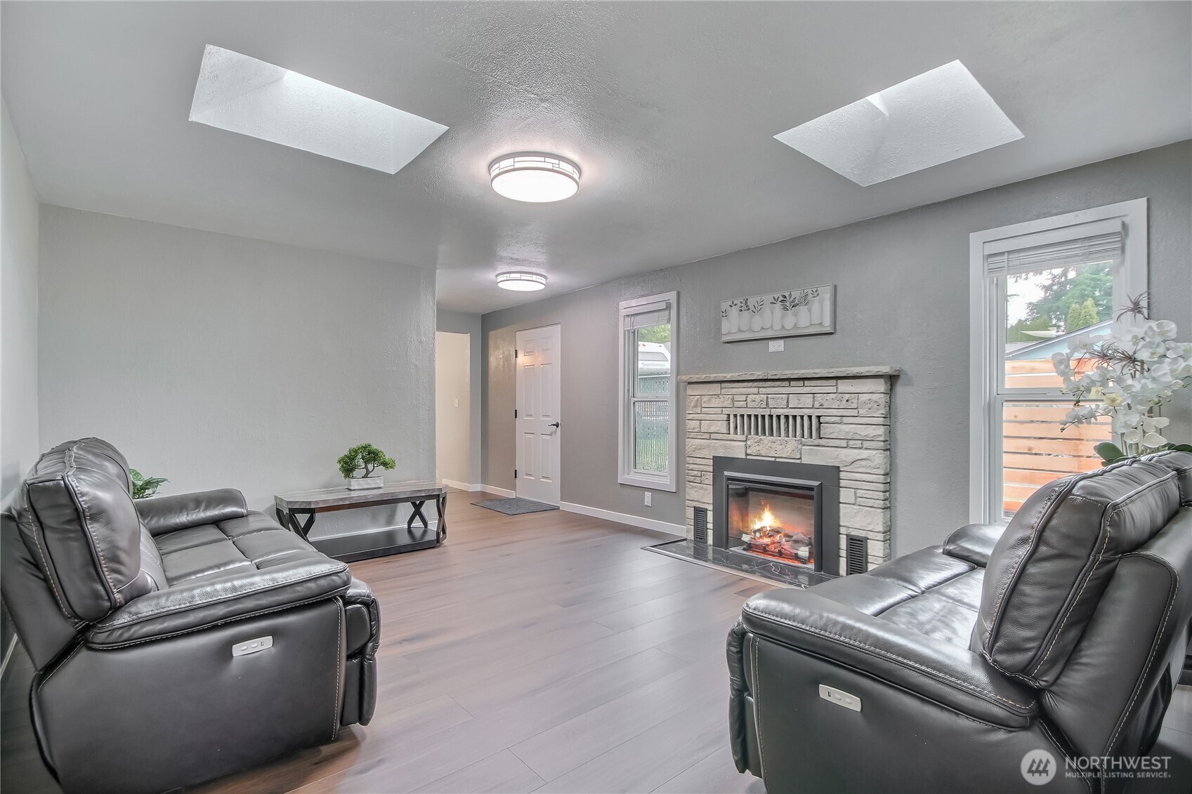 2308 Northeast 27th Street Renton, WA 98056 - Photo 10 of 24 a living room with furniture and a fireplace