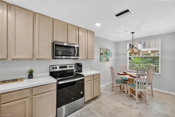 a kitchen with a stove a sink and a microwave