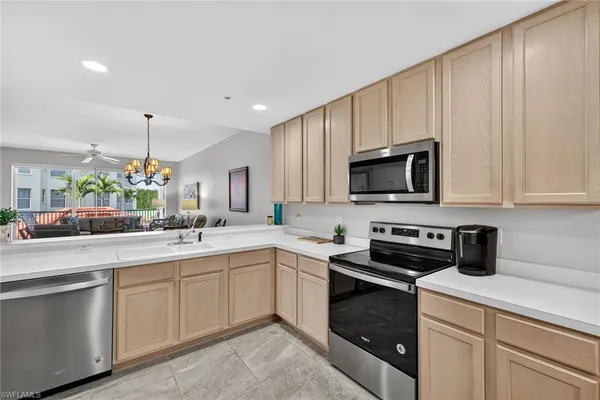 a kitchen with a sink stove and microwave