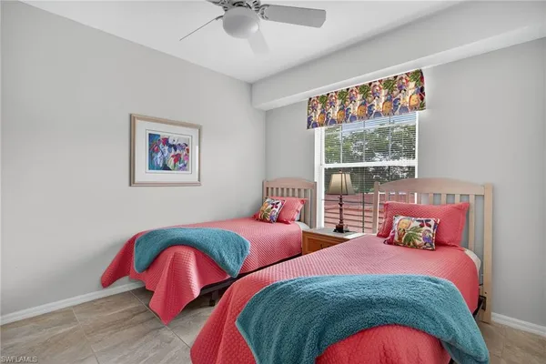 a bedroom with two beds and a painting on the wall