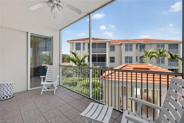 a porch with a table and chairs