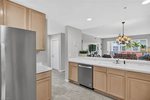a kitchen with white cabinets and center island