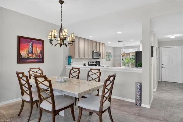 a view of a dining room with furniture a chandelier and wooden floor