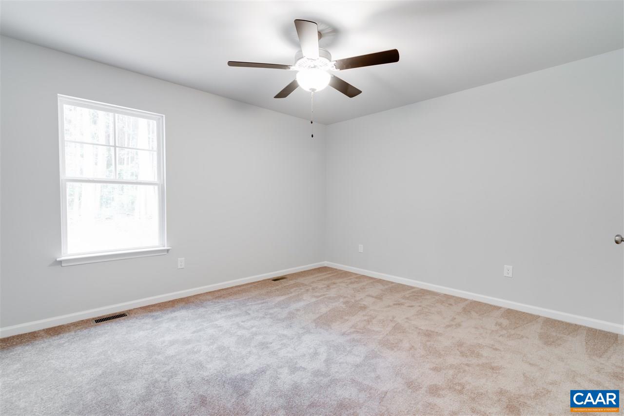 276 Greenes Corner Road Bumpass, VA 23024 - Photo 15 of 16 an empty room with a window and a ceiling fan