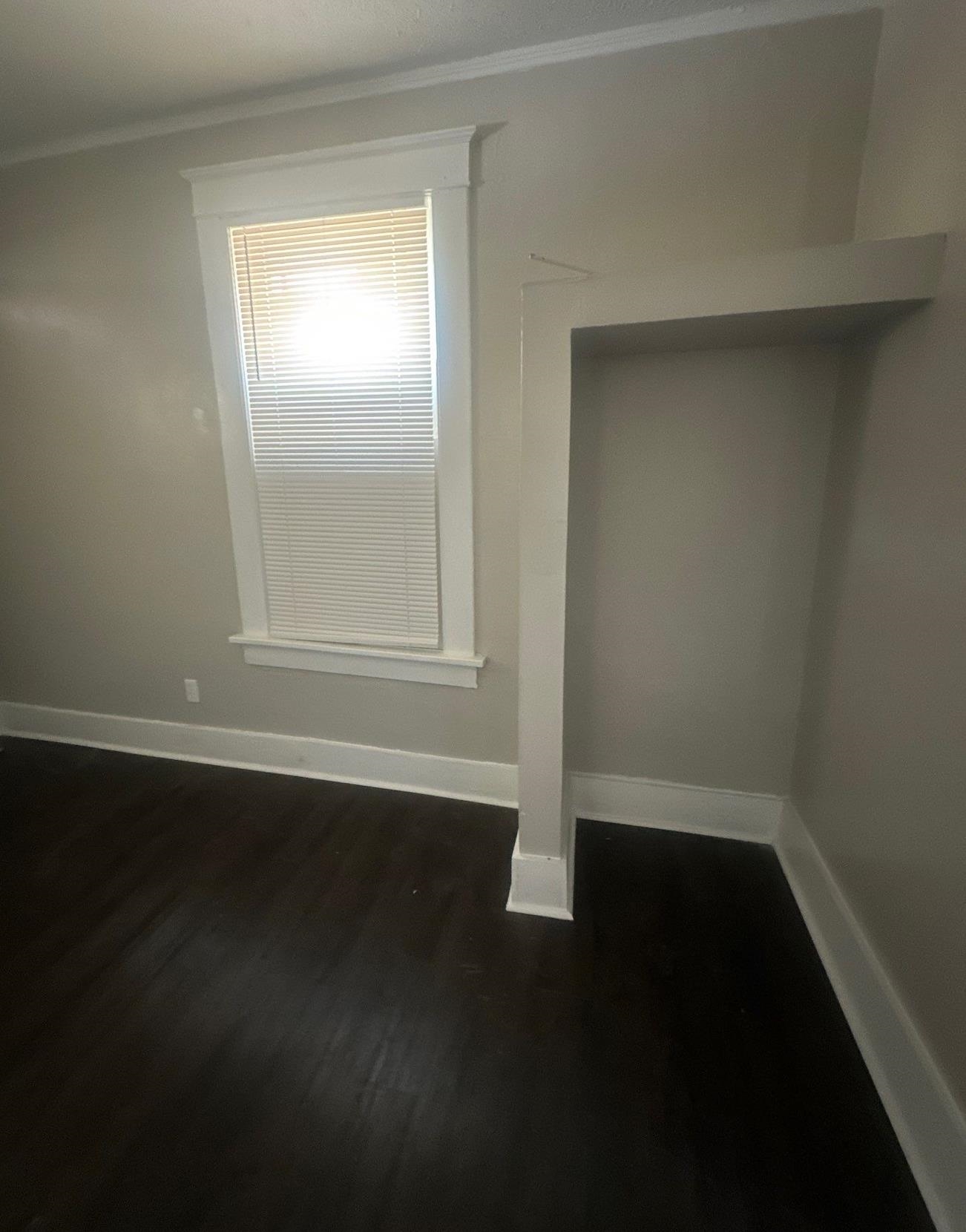 1165 Rayner Street Memphis, TN 38106 - Photo 14 of 16 Dark wood-finish flooring with crisp white baseboards