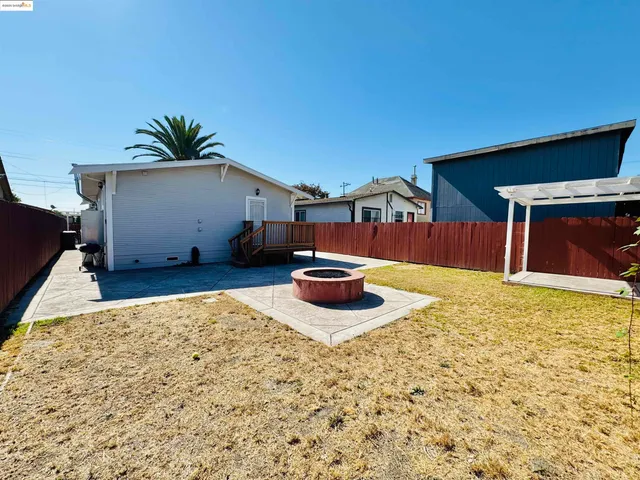 a backyard of a house with table and chairs