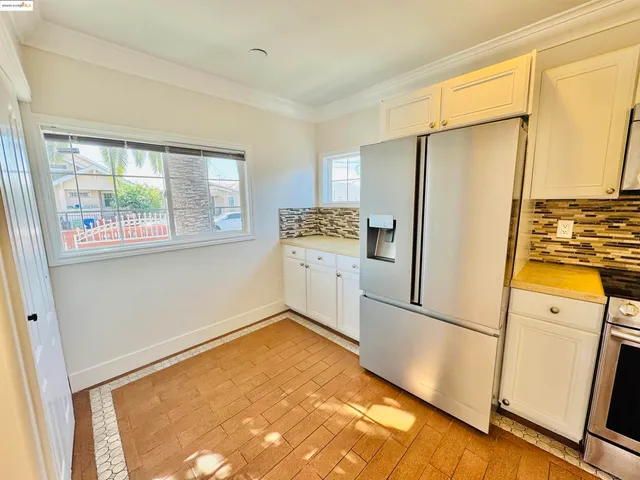 a kitchen with a refrigerator and a stove