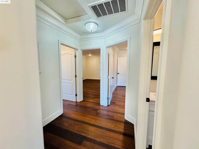 a view of hallway with wooden floor