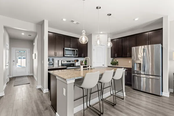 a kitchen with stainless steel appliances a refrigerator stove microwave and cabinets