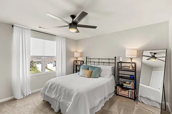 a bedroom with a bed and a window