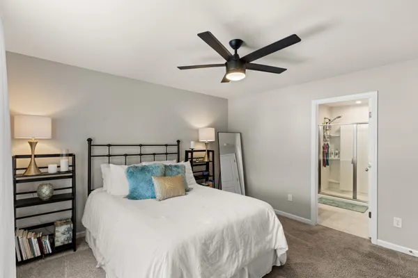 a bedroom with a bed and a view of kitchen