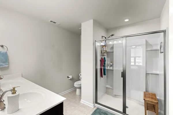 a bathroom with a shower and a sink