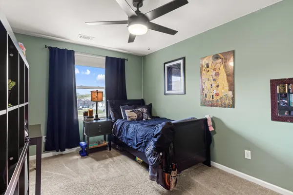 a bed room with a bed and a chandelier