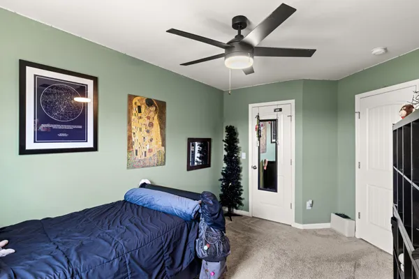 a bedroom with a large bed and a chandelier
