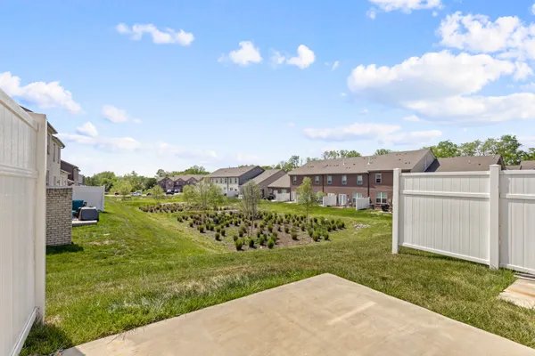 a view of a garden with a building in the background