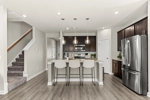 a kitchen with stainless steel appliances a refrigerator stove microwave and cabinets