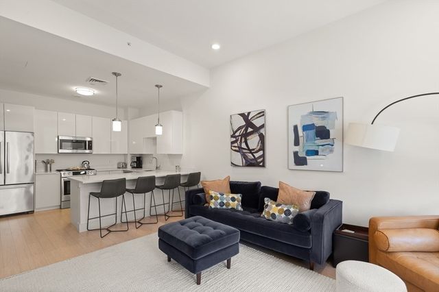 a living room with furniture kitchen view and a kitchen
